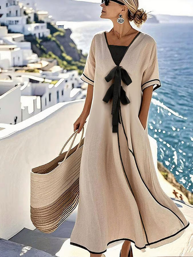 Beige maxi dress with black piping, side view