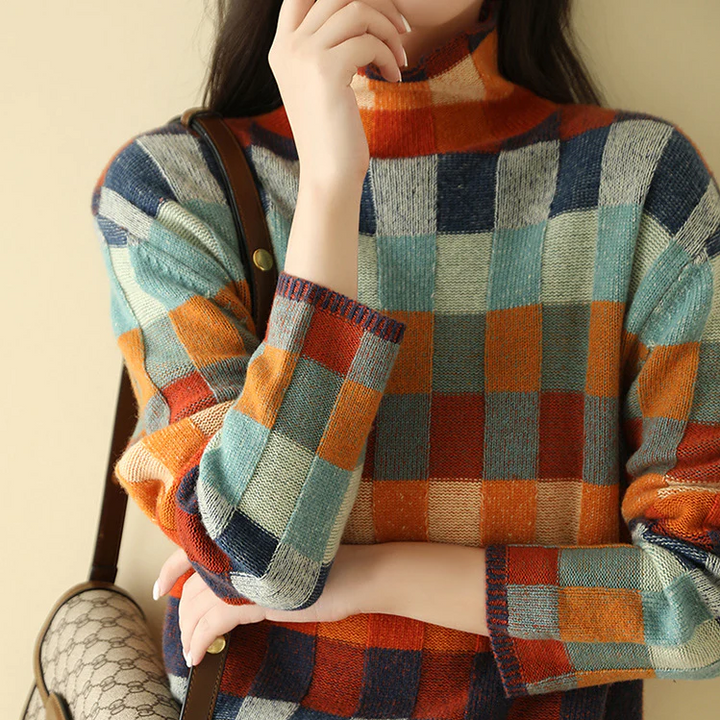 Plaid patchwork knit turtleneck sweater styled with a handbag